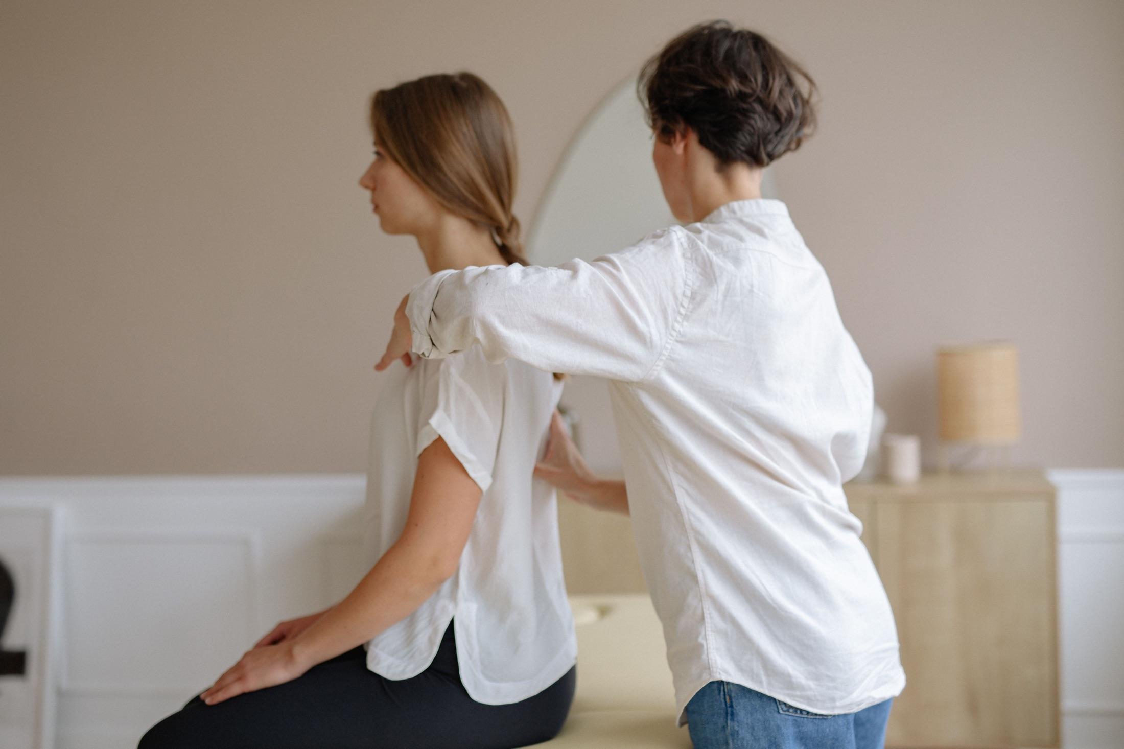 Therapist treating a client’s back during rehabilitation