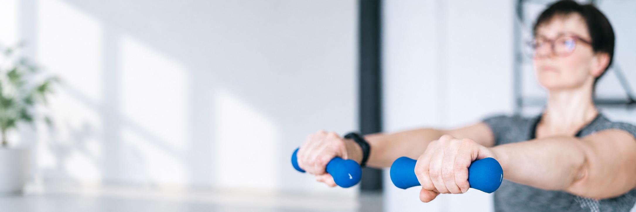 Client performing guided exercise with hand weights